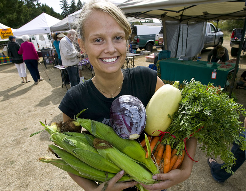 Woman with fresh vegetables at farmers market