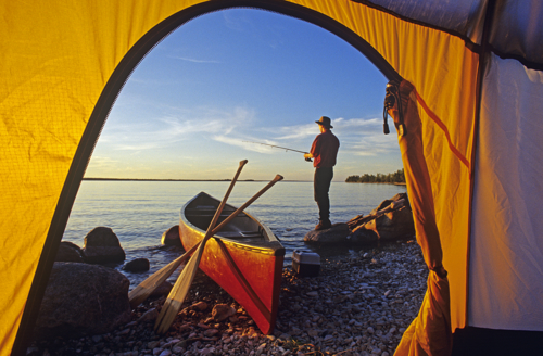 Fishing at sunset from tent with canoe on Little Limestone Lake